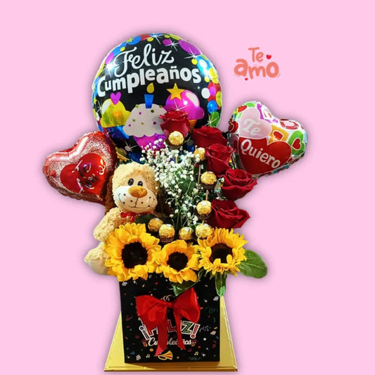 regalo con osito de peluche, flores frescas y bombones Ferrero, perfecto para sorprender en fechas especiales."